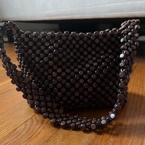 The Sak brown wooden circled underarm tote bag